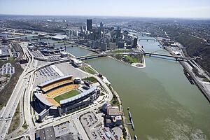 Aerial view of Pittsburgh, Pennsylvania with skyscrapers and stadium and rivers.
