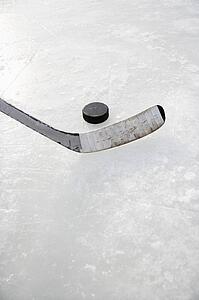 Hockey stick on ice rink to hit puck