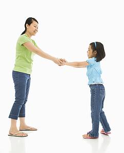 Mother and daughter playing together holding hands