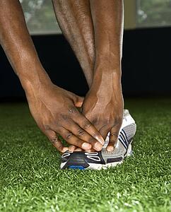 African-American male stretching.