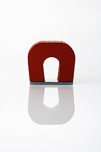 Red magnet on white background.