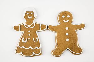 Male and female gingerbread cookies holding hands.