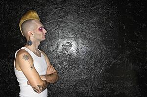 Punk in front of black background