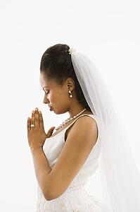 Bride praying with white background.