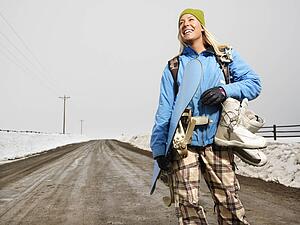 Woman standing on muddy dirt road 