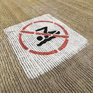 No swimming sign painted on cement.