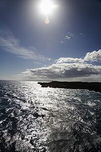 Sun shining on coastline with Pacific ocean on Maui, Hawaii.
