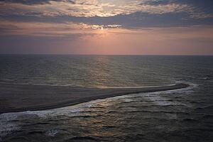 Scenic Bald Head Island North Carolina landscape of shoreline during sunrise.