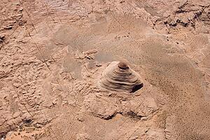Aerial of extruding rock formation in desert landscape of Utah, USA.