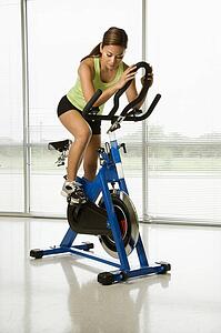 Woman pedaling exercise bicycle
