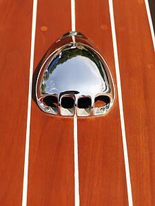 Detail of metal vent on wooden boat.