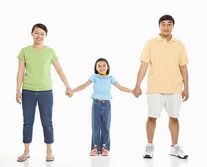 Parents holding hands with daughter 