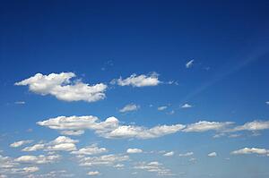 Fluffy clouds in blue sky