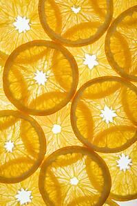 Orange slices arranged in design on white background.