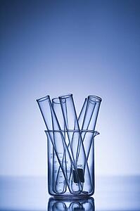 Test tubes in glass beaker with blue tint.