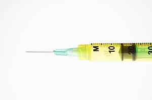 Hypodermic needle on white background.