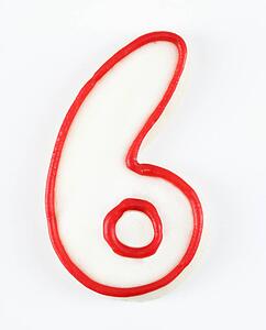 Sugar cookie in the shape of a number six outlined in red icing.