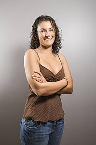 Female with arms crossed smiling 