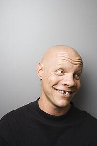 Portrait of mid-adult Caucasian male with missing tooth.