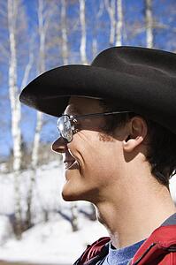 Male wearing sunglasses and cowboy hats