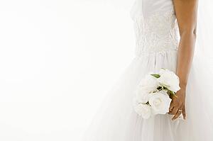 African-American bride holding bouquet.