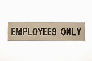 Employees only sign against white background.
