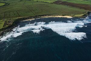 Aerial view of surf spot on coast of Maui, Hawaii with waves