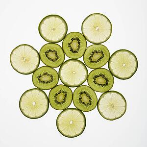 Kiwi and lime fruit slices arranged on white background.