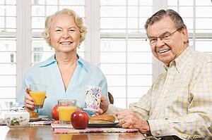 Mature couple having breakfast together