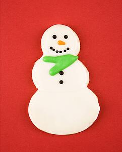 Snowman sugar cookie with decorative icing.