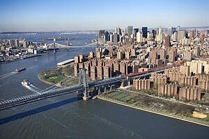 Aerial view of Williamsburg Bridge with Manhattan and Brooklyn bridges in background and view of lower east Manhattan