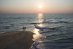 Aerial view of couple on beach in Bald Head Island, North Carolina during sunset