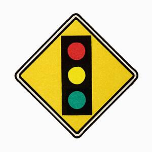 Stoplight ahead road sign against white background.