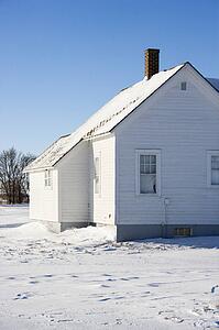 Rural house in snow.