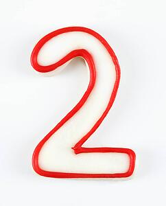 Sugar cookie in the shape of a number two outlined in red icing.