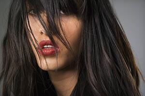 Headshot of pretty young woman with long black hair.
