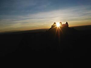 Sun shining through butte at Monument Valley