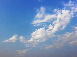 Skyscape of blue sky and white fluffy clouds