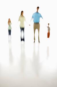 Soft focus family holding hands.