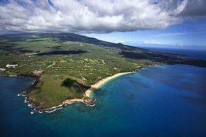Aerial of coastline with sandy beach and crater and Pacific ocean in Maui, Hawaii.