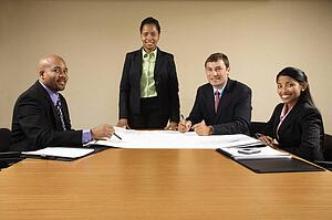 Businesspeople having meeting at conference table.