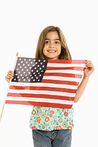 Girl holding American flag against white background.
