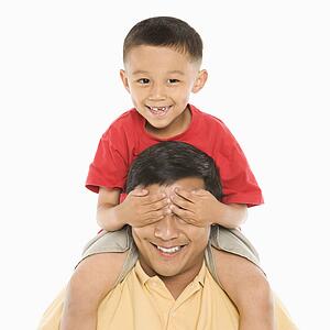 Boy sitting on father's shoulders