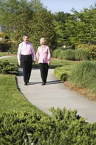 Mature couple walking down sidewalk