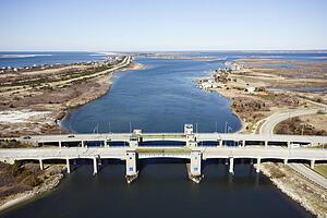 Aerial view of aerial view of waterway with two bridges on Robert Moses Causeway, New York. 