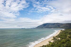 Scenic coastal view from Queensland Rex Lookout with mountains in background under blue sky with clouds