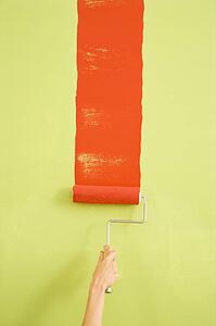 Hand painting red stripe on green wall