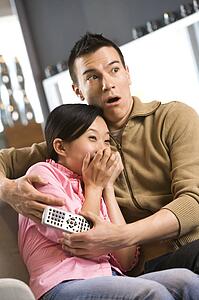 Woman with scared expression while man comforts her