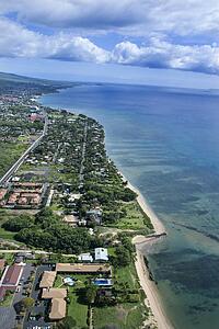Aerial of Maui, Hawaii coastline with beach and buildings.