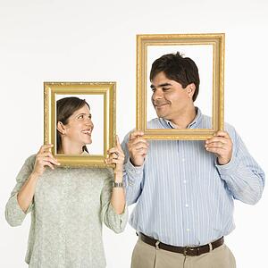 Man and woman looking through frames